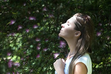 woman smelling air